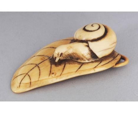 A GOOD JAPANESE EDO PERIOD IVORY NETSUKE, carved in the form of a snail crawling along a veined leaf, 2.2in long.