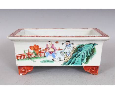 A 19TH CENTURY CHINESE FAMILLE ROSE PORCELAIN JARDINIERE, supported on ruyi scroll feet, the sides painted with scenes of sag