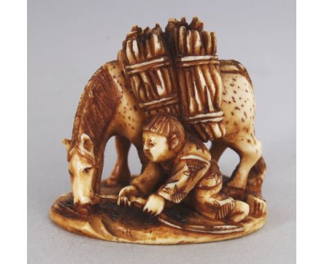 A SIGNED JAPANESE MEIJI PERIOD STAINED IVORY NETSUKE OF A BOY & A HORSE, the boy kneeling and holding the horse’s halter, the