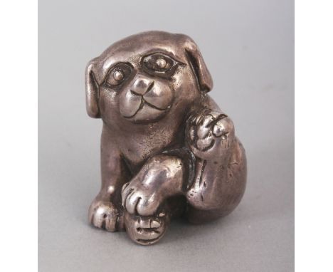 AN UNUSUAL SILVERED NETSUKE OF A PUPPY, 1.6in high.