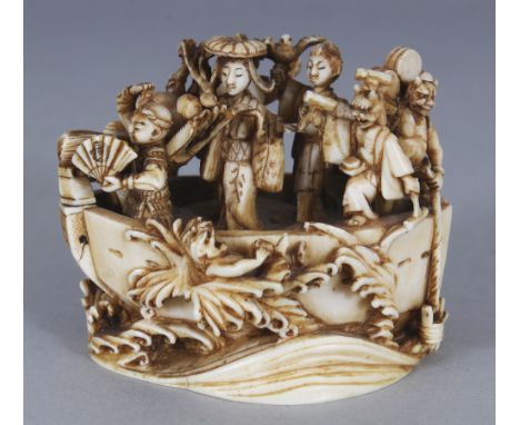 A GOOD LARGE SIGNED JAPANESE MEIJI PERIOD IVORY NETSUKE OF THE TAKARABUNE, the wave supported boat containing five of the Luc