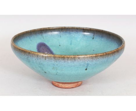 A CHINESE JUN WARE PURPLE SPLASH CERAMIC BOWL, the predominantly blue glaze falling short of the foot, 7.25in diameter & 3.1i
