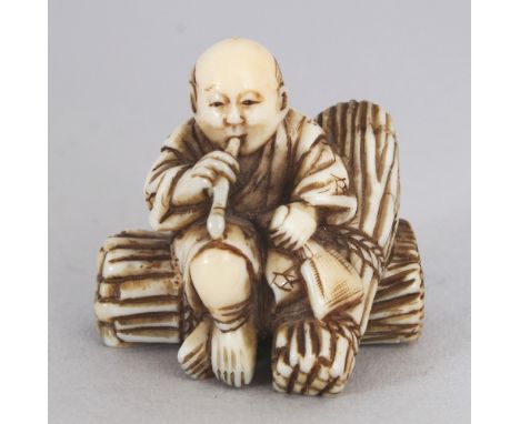 A SIGNED JAPANESE MEIJI PERIOD IVORY NETSUKE OF A FAGGOT GATHERER BY GYOKUZAN, the seated man smoking a pipe and seated on a 