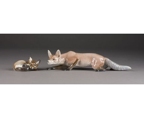 ZWEI FUCHSFIGUREN Deutsch, Rosenthal, 1931 und 1941 Porzellan, polychrom staffiert. L. 9,5 und 30 cm. Unterglasurgrüner Manuf