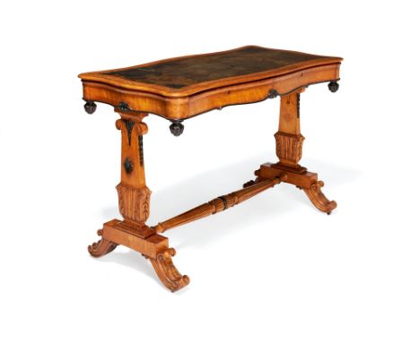 An early Victorian bird's-eye maple and parcel ebonised writing table, circa 1850, in the manner of Holland & Sons, the shape