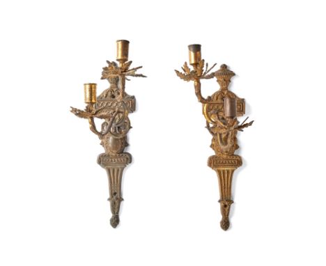 A pair of Northern European gilt brass twin light wall appliques, last quarter 18th century, each with scroll arms cast with 