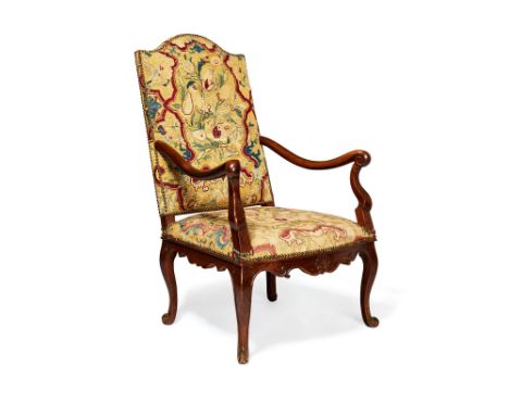 A French walnut and tapestry upholstered open armchair in Louis XV style, 19th century, the high arched back above the arms, 