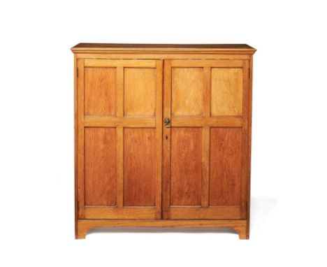 An oak shoe cupboard, by Wylie & Lochhead, first half 20th century, the rectangular top with moulded edge, above a pair of pa