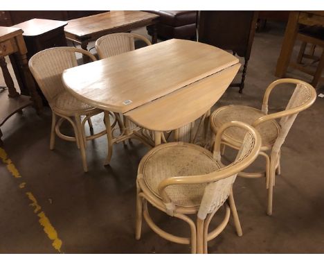 Modern light wood dining table with woven cane panels and four matching bent wood chairs 