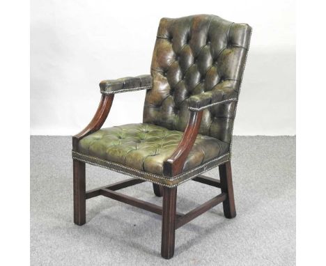 A Georgian style Gainsborough armchair, mid 20th century, upholstered with a green buttoned leather seat and back, on square 