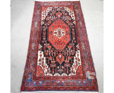 A Turkish woollen rug, with a central medallion, on a blue ground295 x 162cmCondition report: Has overall light wear and dirt