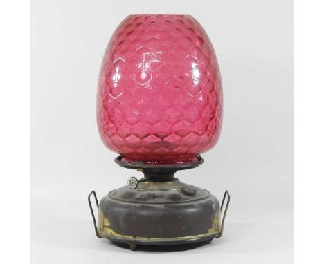 A 19th century oil lamp, with a red glass shade44cm high