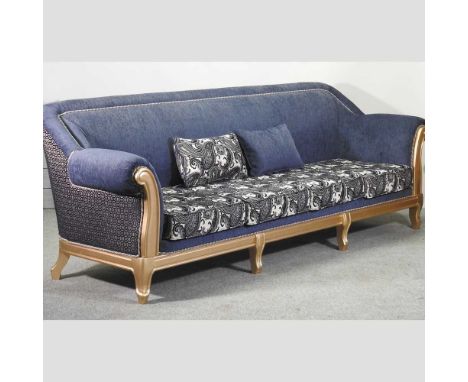 A large modern gilt and blue upholstered sofa, with loose cushions, on gilt legs280w cm