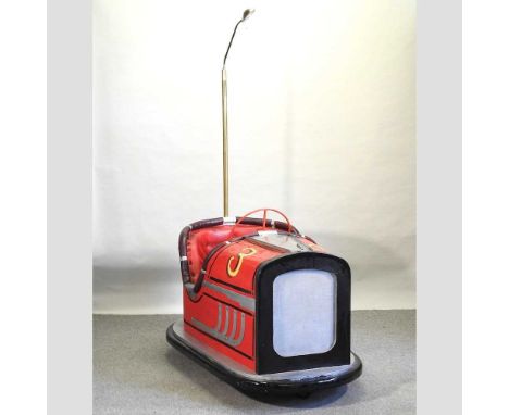 A novelty red painted chair in the form of a fairground dodgem, with an attached reading light97w x 155d x 214h cm