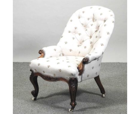 A Victorian button back armchair, upholstered in cream fabric with bee design, on cabriole legs56w x 85h cmCondition report: 