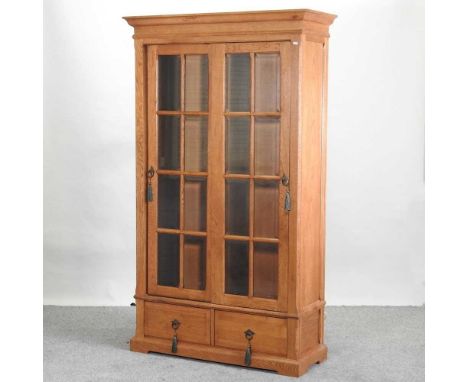 A modern light oak glazed cabinet, enclosed by a pair of sliding doors, with a pair of short drawers below110w x 43d x 190h c