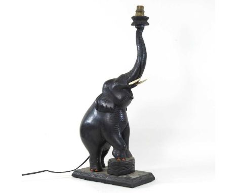 An early 20th century carved wooden table lamp, in the form of an elephant, with trunk raised60cm highCondition report: Dirty