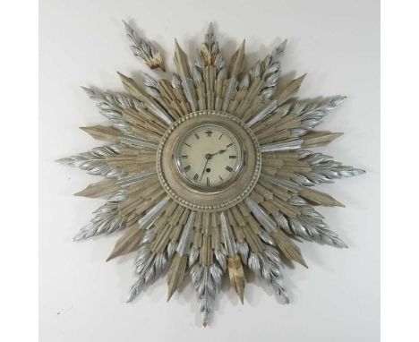 An early 20th century sunburst wall clock, in a painted wooden surround54cm diameterCondition report: One of the ends is brok