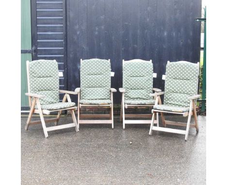 A set of four folding garden chairs, with loose cushionsCondition report: Used and weathered
