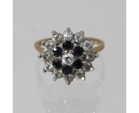 A 9 carat gold sapphire and gem set cluster ring, size I/J, 2.8g, boxedCondition report: Dirty but complete. The surrounding 