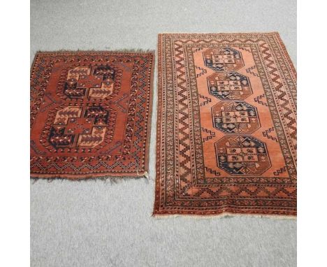 A Turkish woollen rug, having central diamonds, on a red ground, 187 x 111cm together with another smallerCondition report: B