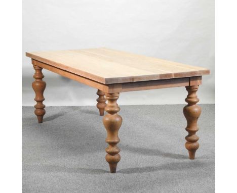 A light oak dining table, on turned legs199w x 91d x 75h cm