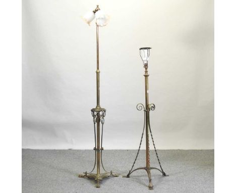 An early 20th century ornate brass standard lamp, on paw feet, 168cm high, together with another (2)
