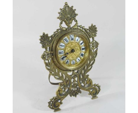 An ornate 19th century brass cased strutt clock, the dial having enamel Roman hours, within a scrolled case, stamped RD 1850C