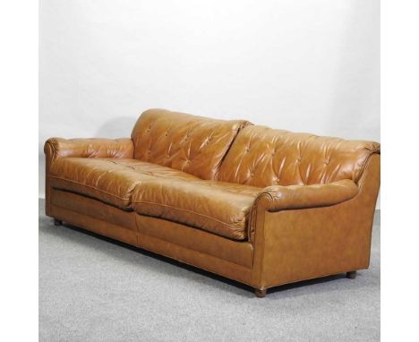 A tan leather upholstered sofa. with a button back217w x 90d x 74h cmCondition report: Slightly dirty, with some light scuffs