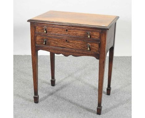 A 1930's oak canteen table, by Harrods, fitted with a pair of drawers, bearing a label Harrods Ltd London SW167w x 46d x 79h 