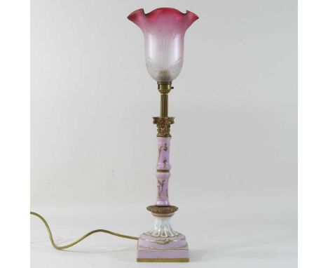 A 19th century French pink pottery lamp, in the form of a column, with a later glass shade53cm high