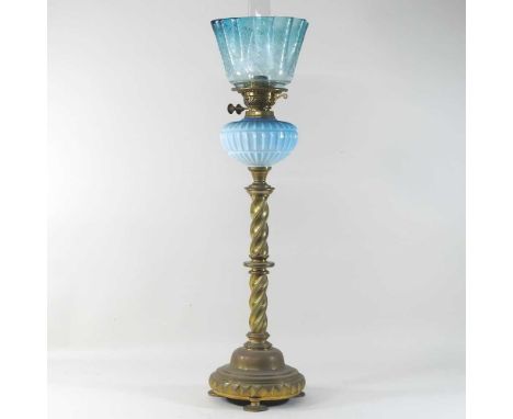 A 19th century brass oil lamp, having a spirally twisted column, blue opaque reservoir and 19th century etched frilled glass 
