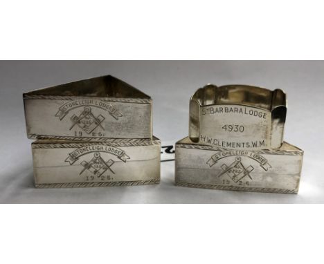 THREE SILVER TRIANGULAR NAPKIN RINGS WITH MASONIC ENGRAVED EMBLEM AND A SQUARE CANTED EDGED NAPKIN RING