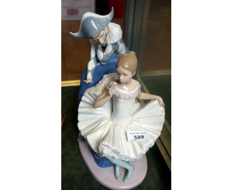 A large Nao Lladro figure group of a harlequin and a ballerina.