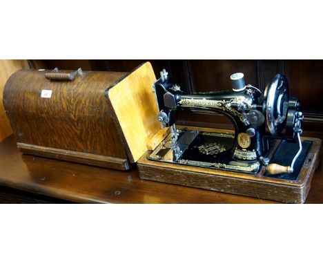 A Vintage oak cased sewing machine.