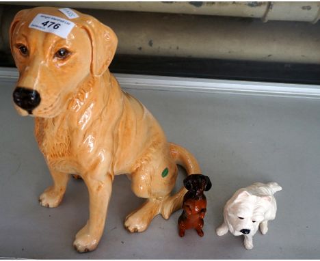 A Beswick ceramic fireside model of a golden retriever together with a Royal Doulton model of a terrier and a Beswick model o