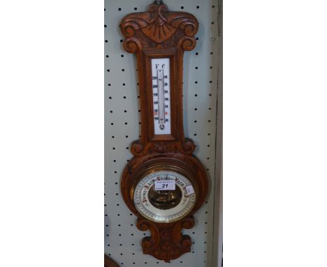 A mid 20th Century carved oak banjo barometer of small proportions.