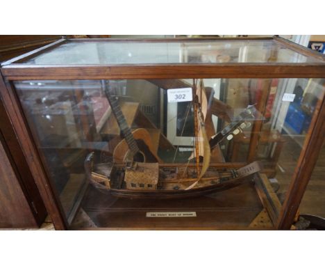 A Vintage model of the Paddy Boat of Burma, fitted in glazed cabinet.