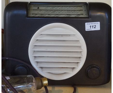 A vintage bakelite radio, together with a Osram additional bulb.