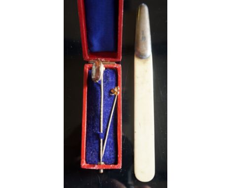 A hallmarked silver mounted ivory page turner, a pinchbeck tiepin with cameo style mount and a further tiepin.