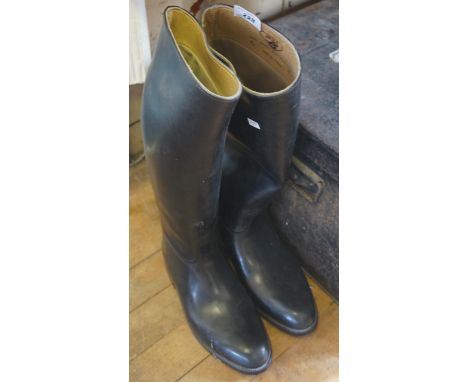 A vintage pair of black leather riding boots, made by Aigle, size 7.