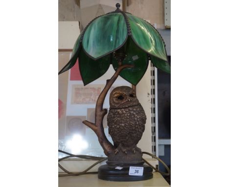 A gilt lamp base in the form of a barn owl, with a Tiffany style shade.