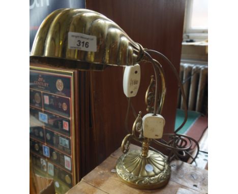 An early 20th Century brass table lamp with cornucopia shade.