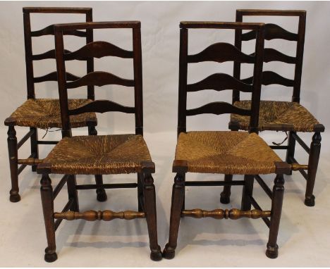 A set of four 18th Century ash ladder back chairs
With rush seats and later squab cushions, raised on front turned supports u