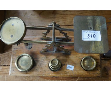 A set of Post Office balance scales of assorted weights.