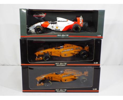 Minichamps - three 1:18 scale diecast F1 cars by Minichamps with a McLaren theme, models are in excellent to mint condition i