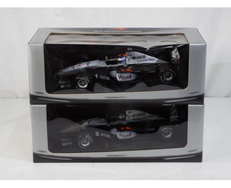 Minichamps - two 1:18 scale diecast McLaren F1 cars by Minichamps with a West Tobacco branding, includes RN1 and RN2, models 