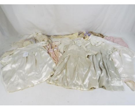 A collection of vintage dolls / baby clothing to include some silk examples