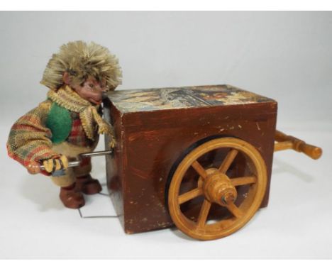 Steiff - a Peter Figuren Mecki Hedgehog Organ Grinder musical box by Steiff, measuring  6 cm x 13 cm x 11 cm with key in plac