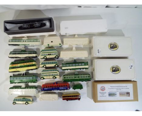 A collection of diecast and pottery model trams and buses to include OO scale resin kits and accessories, Atlas Models, Heato